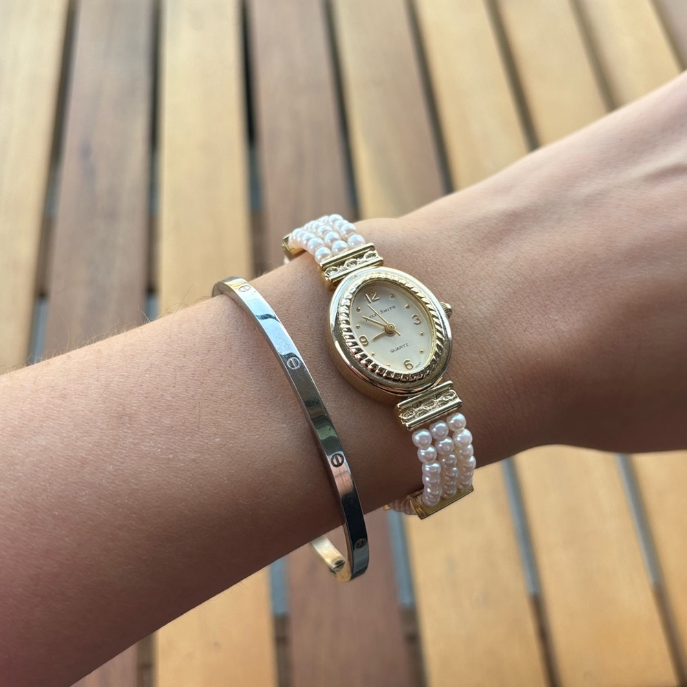 Jaclyn Smith vintage gold tone and white pearl watch.